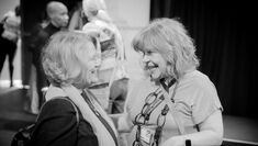 Cheri Shone and Tanya Zybutz face each other smiling and talking at the launch of the 4th edition of the AchieveAbility E-Journal